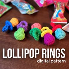 crocheted lollipop rings on a wooden table with candy bags in the background