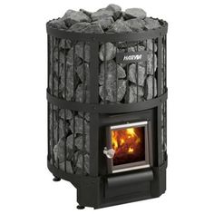 a black stove with rocks on top and the door open to show it's fire