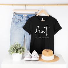 Looking for a fun and stylish way to show your love for your favorite aunt? Look no further than our "Aunt Like a Mom Only Cooler" t-shirt! Made from high-quality materials, this comfortable and durable tee is the perfect addition to any auntie's wardrobe. The design features the humorous phrase "Aunt Like a Mom Only Cooler" in trendy font, making it a great conversation starter and a unique way to show your appreciation for your aunt's important role in your life. This funny auntie tee makes a Cute Aunt Tshirts, Baby Shower Shirts For Aunts, Aunt Shirts Funny Teepublic, Crazy Aunt Shirt, Aunties Bestie Shirt, Aunt Birthday Gift, Aunt Birthday, Cool Aunt, Trendy Fonts