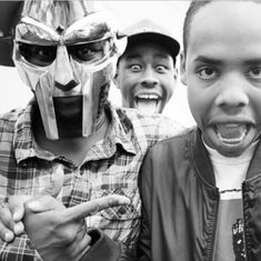 three men wearing masks and pointing at the camera