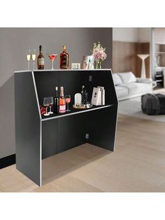 a black bar with wine glasses and bottles on it