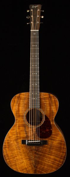 an acoustic guitar is shown against a black background