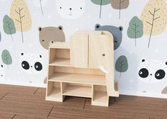 an animal themed wallpaper in a child's room with a wooden desk and chair