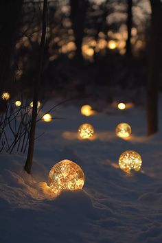 some lights that are glowing in the snow