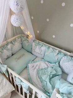 a baby crib with blue and white bedding