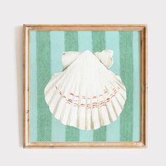 a painting of a seashell on a green and white striped background in a wooden frame