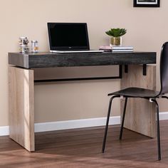 a computer desk with a laptop on it and a chair in front of the desk