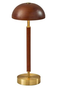 a wooden and brass table lamp on a white background