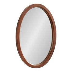 a round mirror on a white wall with wood trim around the edges and an oval wooden frame