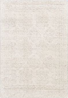 a white rug with an intricate design on the front and back side, in shades of beige