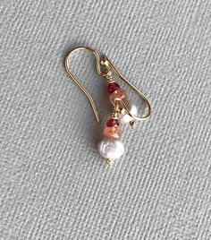 Sunstone, Garnet and Pearl Earrings These petite gemstone dangles are rich with color and texture. Glittery peach sunstone sits between smooth gray pearls and brick red garnets, for earrings that glow and sparkle. Wire-wrapped onto gold filled ear wires, these look really lovely with any skin tone and are just the right size for everyday wear. LENGTH: One inch, including ear wires GEMSTONES: Sunstone - faceted rondelles, 4mm Garnet - faceted rondelles, 3mm Gray freshwater pearls METAL COMPONENTS Clay Elephant, Stack Earrings, Garnet And Pearl, Sunstone Earrings, Earring Pearl, Freshwater Pearl Drop Earrings, Beads Ideas, Stacked Earrings, Earrings Gemstone