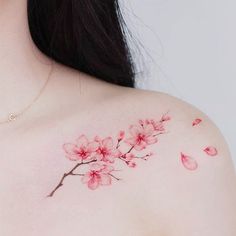 a woman's chest with pink flowers on it