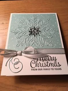 a christmas card with a snowflake on it