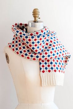 a mannequin wearing a red, white and blue scarf on top of a dummy