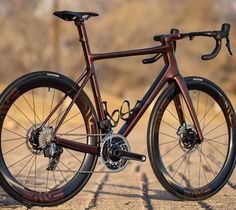 a red bike parked on top of a brick road