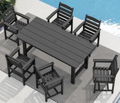 an outdoor table and chairs next to a swimming pool