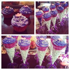 cupcakes with purple frosting and bows are arranged in cones on the table