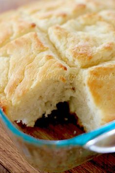 a loaf of bread in a glass dish with a spoon