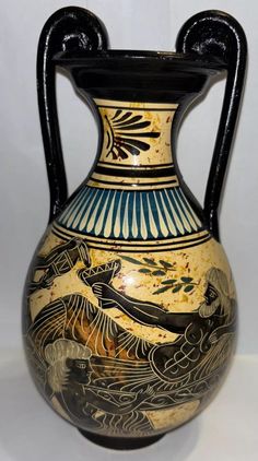 a black and gold vase sitting on top of a table