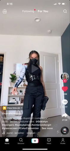 the woman is wearing a mask and black pants