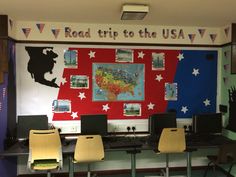 a classroom with desks and computers in front of a wall that says road trip to the usa