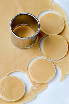 cookie dough being rolled out on top of each other with a ring in the middle