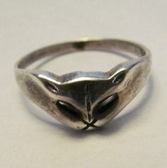 This eerie cat ring has 952 stamped on the inside, it is 95.2 % silver. There are some dark stones for the eyes and is sized at 4 3/4. See picture #2 of it on the ring sizer. Wear as is or give it a polish to make it shine. It is very unique! The face is kind of eerie. Nice for Halloween wear, great for the cat lover/collector. I will send it via USPS. www.etsy.com/shop/207VINTAGEPLUS Visit my other shop at www.etsy.com/shop/SEWMANYTHINGSbyNANCY. b/w/c/box Silver Unique Jewelry, Weird Rings, Jewelry Moodboard, Pretty Silver Jewelry, Cat Rings Jewelry, Weird Accessories, Cat Memorial Jewelry, Cat Rings, Silver Cat Ring