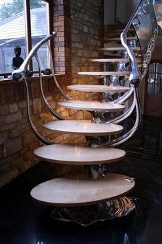 a spiral staircase made out of wood and metal