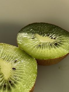 two slices of kiwi fruit sitting on top of each other