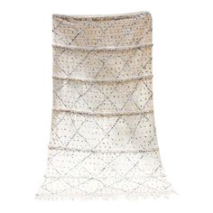 a white rug with fringes and beads on the bottom, in front of a white background