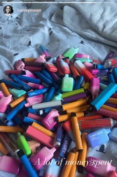 a pile of crayons sitting on top of a bed