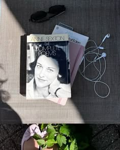 a book sitting on top of a table next to a potted plant