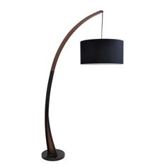 a floor lamp with a black shade on the base and a wooden pole in front of it