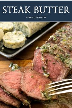 the steak has been sliced and is ready to be eaten with a fork on the cutting board