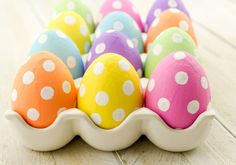 an egg tray filled with colorful painted eggs