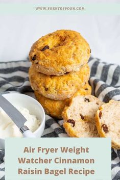 a stack of biscuits next to a bowl of cream and a knife on a towel