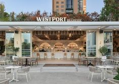 an outdoor restaurant with white tables and chairs