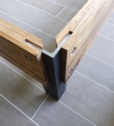 a wooden bench sitting on top of a tiled floor