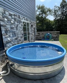 an inflatable swimming pool on the side of a house