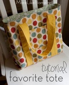 a tote bag sitting on top of a white chair