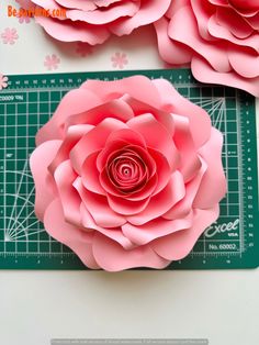 the paper flowers are being cut out on the cutting board and ready to be put together