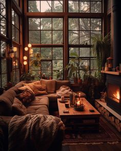 a living room filled with lots of furniture next to a fire place in a window