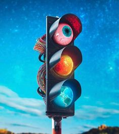 a traffic light with two different colored lights on it's pole and the sky in the background