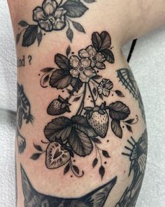 a woman's thigh with flowers and birds on it, in black and white