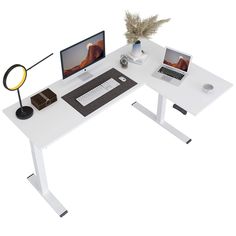 a computer desk with two computers on it