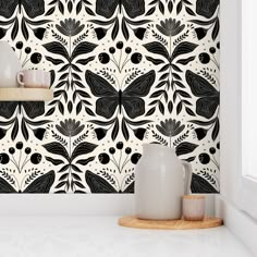 a black and white wallpaper design with flowers on it's back dropper