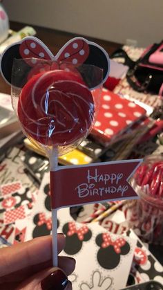 a minnie mouse lollipop with a happy birthday sign on it