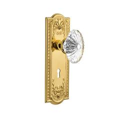 an ornate brass door handle with glass knob