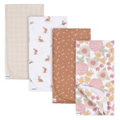 four baby swaddles in various colors and patterns, including one with a bunny on it