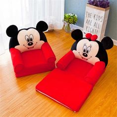 two mickey and minnie mouse chairs sitting on top of a wooden floor next to each other